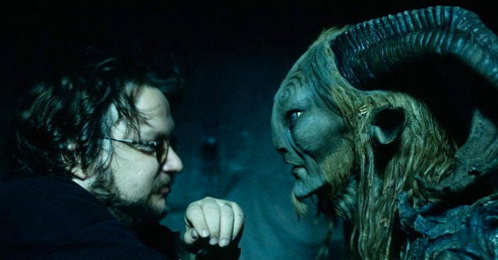 Director Guillermo del Toro with a creature in his film