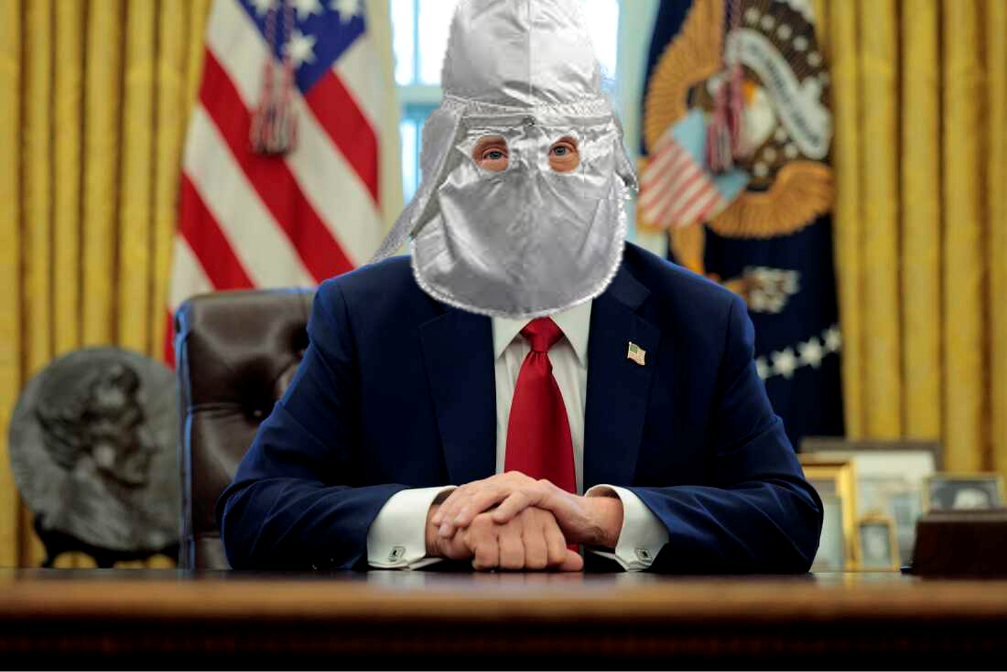 Image of Donald Trump, seated behind the Resolute Desk in the Oval Office, wearing a Ku Klux Klan type hood. 