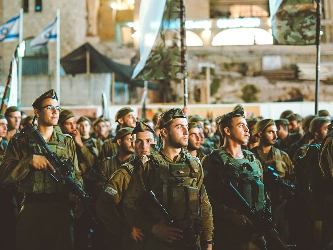 group of armed men with white flag