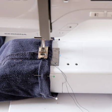 hemming blue pants with a sewing machine