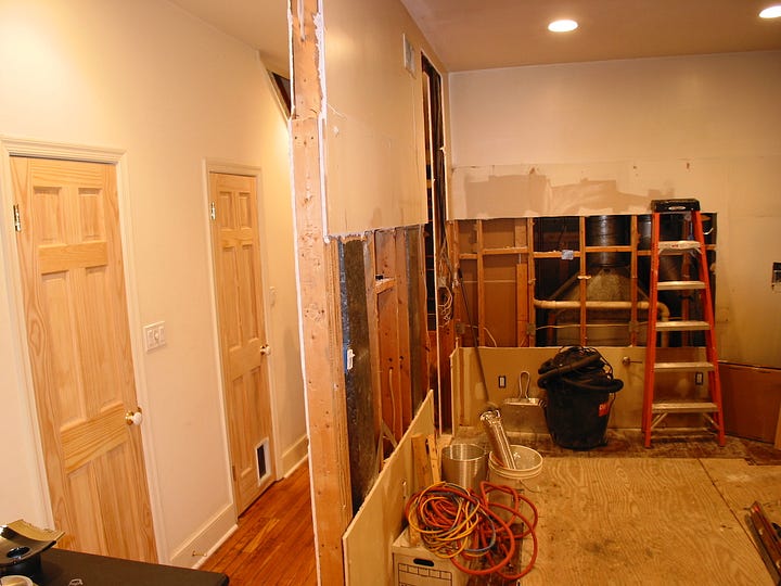 Two photos of the interior of a house undergoing renovation.