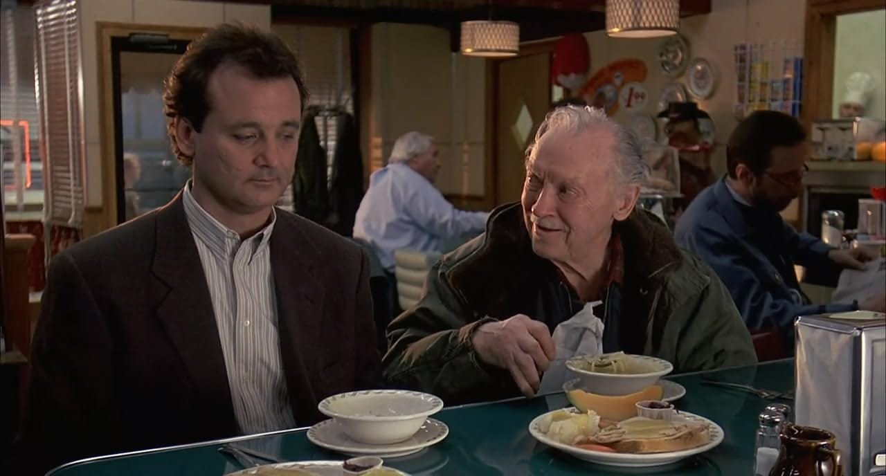 The old man tucking into the soup and sandwich Phil just gave him