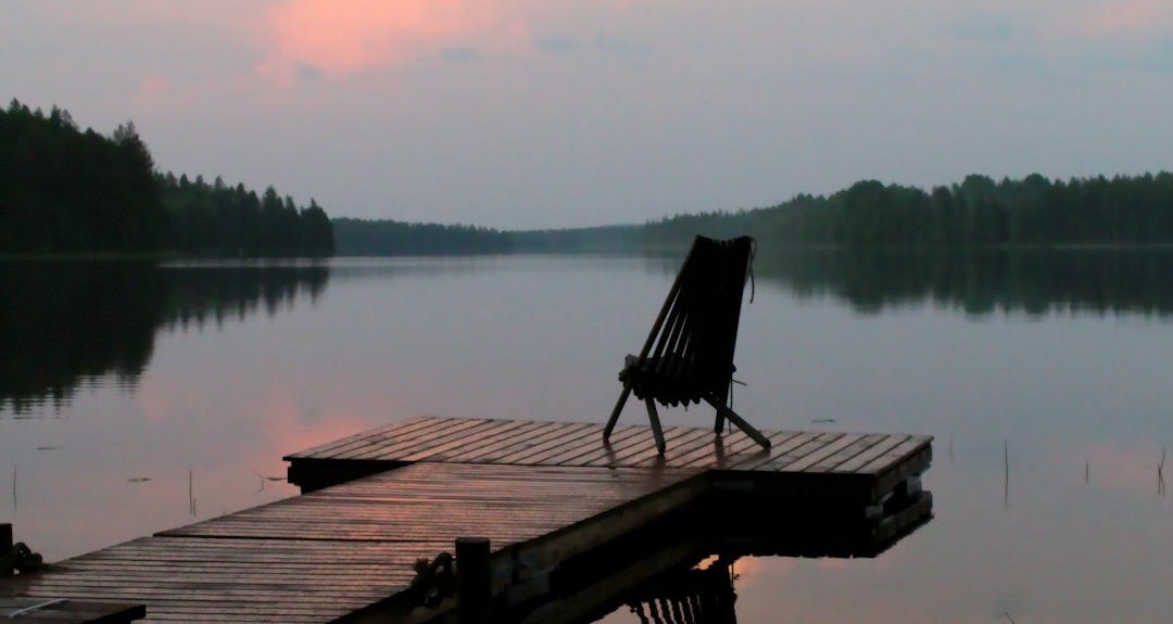 brown wooden bench on dock near lake during daytime brown wooden bench on dock near lake during daytime
