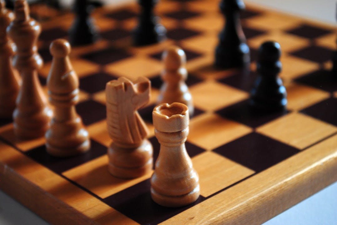 brown wooden chess piece on chess board brown wooden chess piece on chess board
