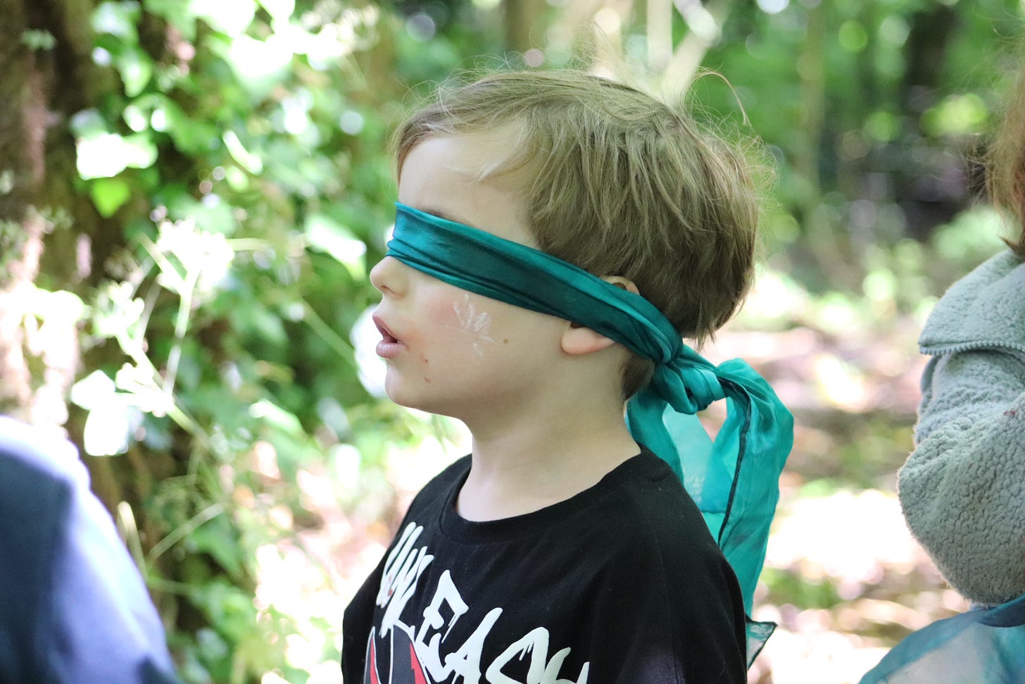 Boy blindfolded with a silk scarf