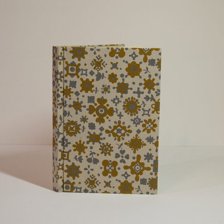 A variety of handbound books and a zine.