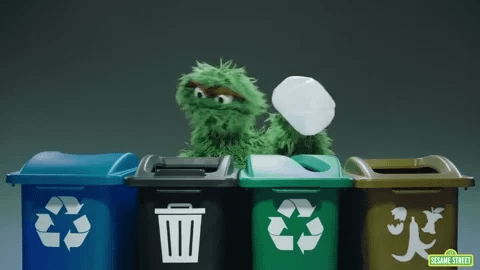 Oscar the Grouch puts a plastic bottle in the recycling. Oscar the Grouch puts a plastic bottle in the recycling.