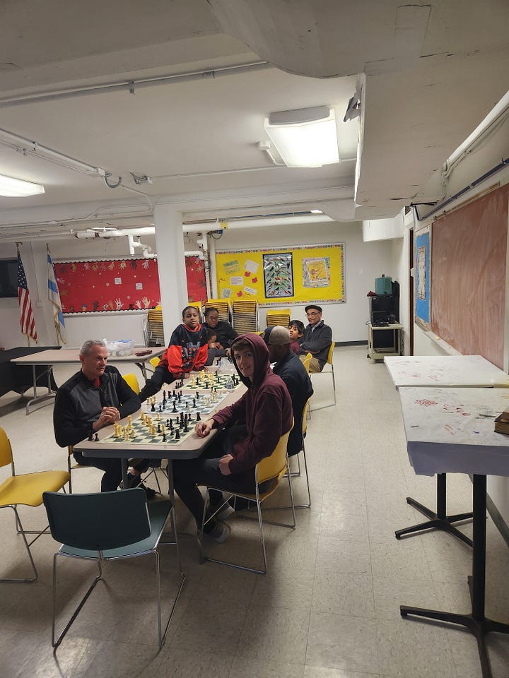 Image 1: Our puzzle gurus finished the job! Image 2: Our Chess Club in full swing Image 3: Our building on a beautiful winter day Image 4: A staff member's cat going on strike for more treats! Image 5: A staff member's cat who also wants to go on the trip