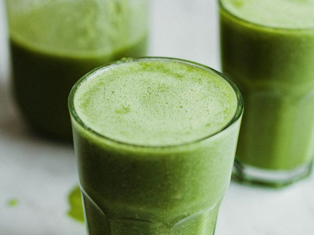 green liquid in clear drinking glass