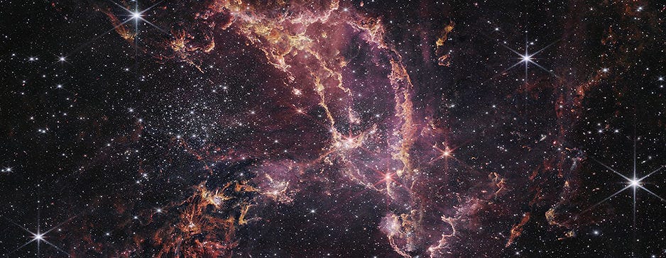 A recent image of NGC 346, a star-forming region within the Small Magellanic Cloud (SMC), taken by the James Webb Space Telescope (JWST). The image showcases a dynamic and colorful nebula with bright stars scattered throughout. The nebula features intricate structures and filaments in shades of pink, purple, and orange, set against a dark star-filled background. The text beneath the image describes NGC 346 as one of the most dynamic star-forming regions in nearby galaxies. A recent image of NGC 346, a star-forming region within the Small Magellanic Cloud (SMC), taken by the James Webb Space Telescope (JWST). The image showcases a dynamic and colorful nebula with bright stars scattered throughout. The nebula features intricate structures and filaments in shades of pink, purple, and orange, set against a dark star-filled background. The text beneath the image describes NGC 346 as one of the most dynamic star-forming regions in nearby galaxies.