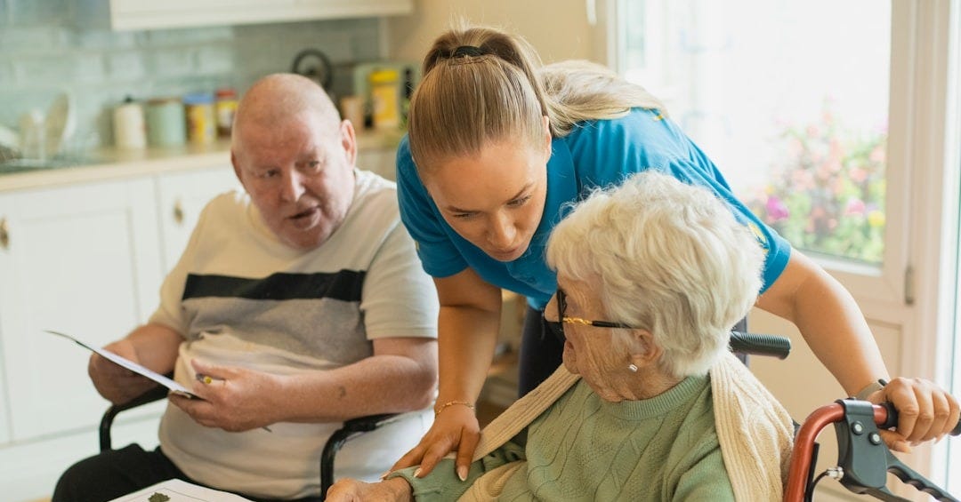 Caregiver assisting elderly couple with coloring Caregiver assisting elderly couple with coloring
