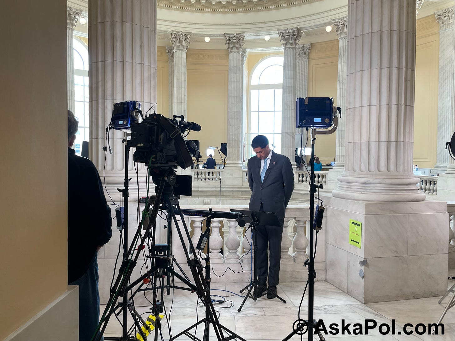 An Indian businessman in suit prepares to speak into a camera © AskaPoluaps.com An Indian businessman in suit prepares to speak into a camera © AskaPoluaps.com