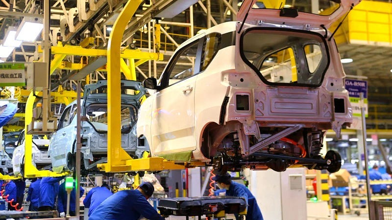 Workers assemble a Wuling Hongguang Mini EV, an all-electric microcar manufactured by SAIC-GM-Wuling, at a plant of the joint automaker in Qingdao in east Chinas Shandong province Tuesday, Nov. 30, 2021.