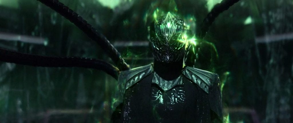 This image shows a figure later identified as the Borg Queen standing on the bridge of the U.S.S. Stargazer. The Queen is dressed in black from head to toe, has two tentacles emerging from her back, and is covered in the green light associated with the Borg. This image shows a figure later identified as the Borg Queen standing on the bridge of the U.S.S. Stargazer. The Queen is dressed in black from head to toe, has two tentacles emerging from her back, and is covered in the green light associated with the Borg.