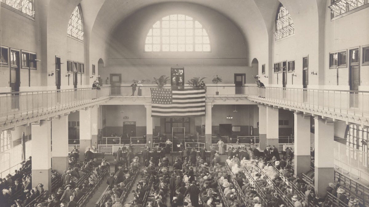 Immigrants seated on long benches, Main Hall, U.S. Immigration Station, c. 1902–1913. New York Public Library, The Miriam and Ira D. Wallach Division of Art, Prints and Photographs.