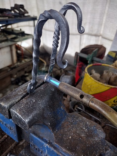 Photos of the project progressing from rebar to final hooks.