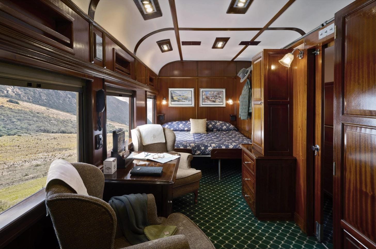 Luxury suite aboard Rovos Rail featuring elegant furnishings and panoramic windows. Luxury suite aboard Rovos Rail featuring elegant furnishings and panoramic windows.