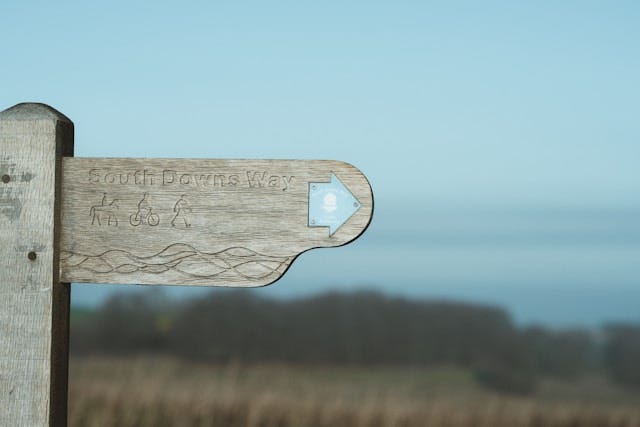 A wooden signpost showing the South Downs Way.