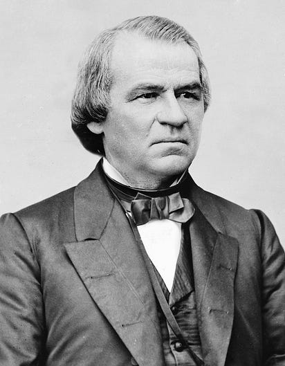 Andrew Johnson portrait by Matthew Brady; wearing suit photo from chest up; balding, grey hair, head turned three quarters, scowling