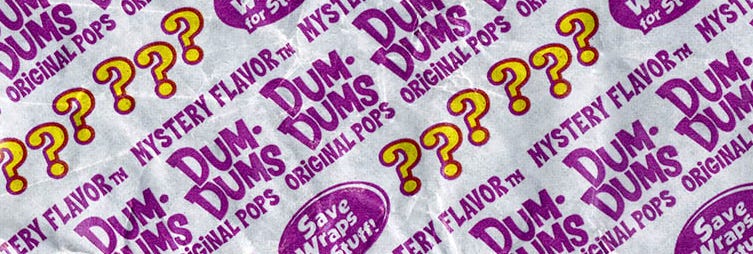 Dum dum wrapper for mystery flavor, bright purple with question marks all over it
