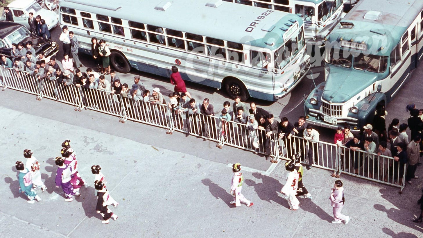 A captivating street scene from Japan, likely Yokohama, 1966, featuring a geisha alongside bustling buses.