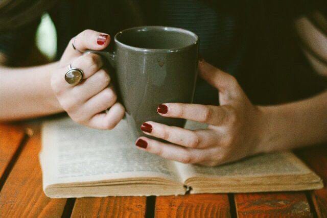 May be an image of 1 person, studying and coffee cup