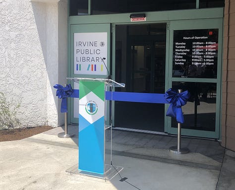 Ribbon Cutting, Chris Slama, and a mom and chld inside the library