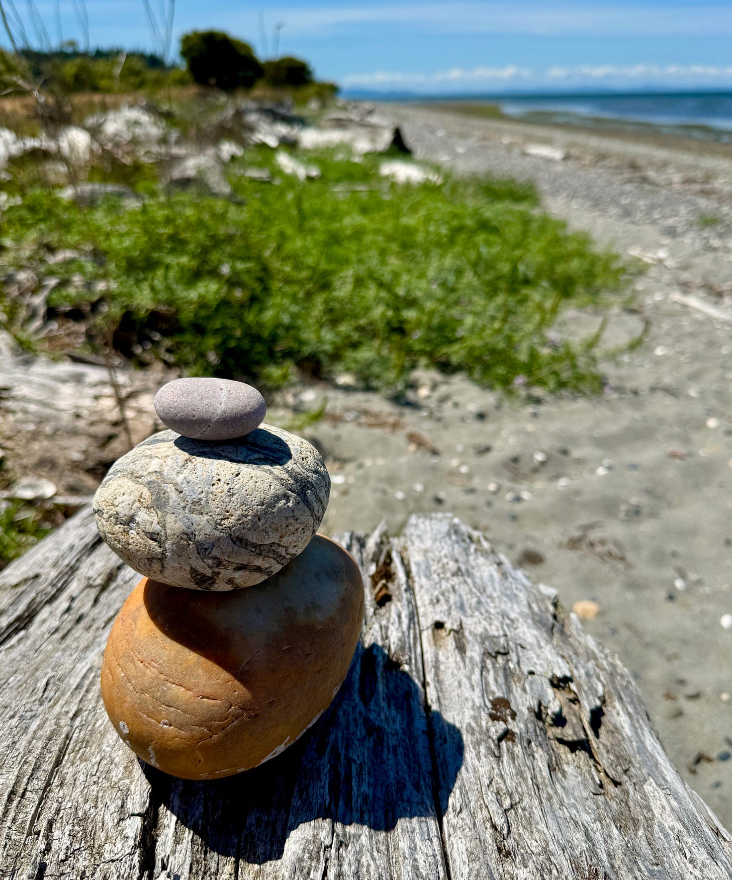 Whispering prayers as I stack stones by the sea … Photo by JPC. Whispering prayers as I stack stones by the sea … Photo by JPC.