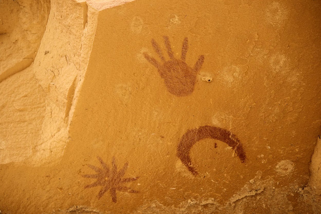 Red painted images onPhotograph of a sandstone wall depicting a hand, a crescent moon, and a ten-pointed star--all in red paint from Chaco Canyon, New Mexico Red painted images onPhotograph of a sandstone wall depicting a hand, a crescent moon, and a ten-pointed star--all in red paint from Chaco Canyon, New Mexico
