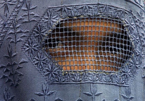 This may contain: a piece of clothing that has been made to look like a face with an orange patch on it
