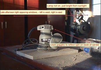 Lighting set up of power sander on a board
