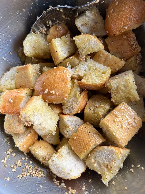 Voorbereiding: "Stukjes brood gemengd met gekruide olijfolie, verspreid op een bakplaat klaar om te bakken."  Tijdens het bakken: "Croutons die goudbruin worden in de oven op een bakplaat."  Eindresultaat: "Goudbruine, knapperige croutons in een schaal, klaar om te serveren."  Met een salade: "Frisse groene salade gegarneerd met zelfgemaakte knapperige croutons."  Close-up: "Close-up van perfect goudbruine en kruidige croutons met een knapperige textuur."