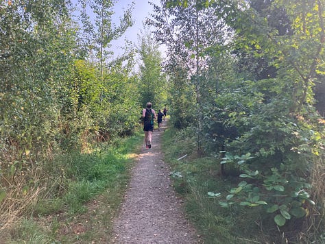 Different views of the course, including a narrow section and a sign marking straight on after one lap, right to the finish after the second