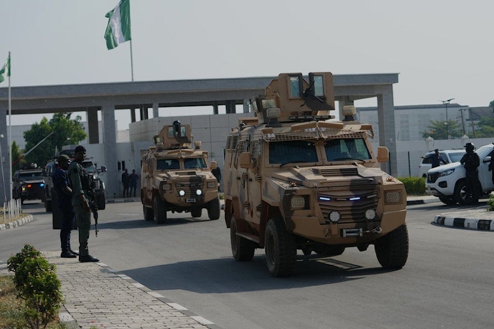 Nigerian Police and Army officers arrive for an event in Minna, Nigeria, on Dec. 22, 2025. (AP Photo/Sunday Alamba) Nigerian Police and Army officers arrive for an event in Minna, Nigeria, on Dec. 22, 2025. (AP Photo/Sunday Alamba)