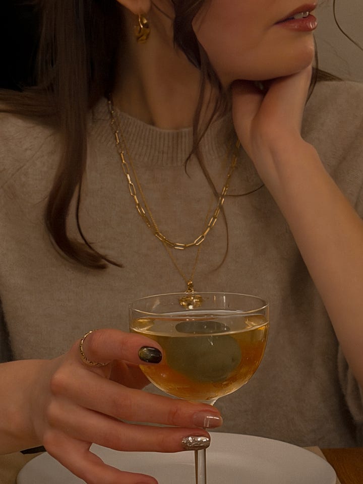Laura Lombardi vola hoops, sezane irma link chain and monica vinader fine chain necklace and pendant in gold.