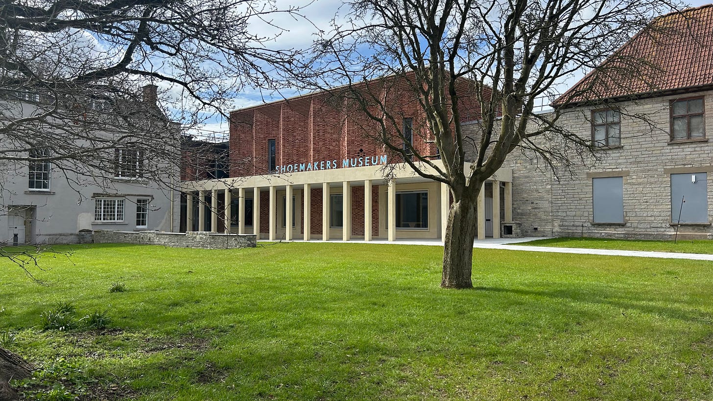 The Clarks Shoemakers Museum at Street in Somerset. Build alongside Clarks Shopping Village. The museum is modern and yet built into old buildings. In front is a green with trees. The Clarks Shoemakers Museum at Street in Somerset. Build alongside Clarks Shopping Village. The museum is modern and yet built into old buildings. In front is a green with trees.