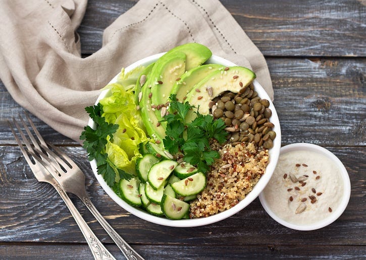 Green Buddha Bowl With Lentils, Quinoa, Avocado, Cucumber, Lettuce, and Tahini dressing