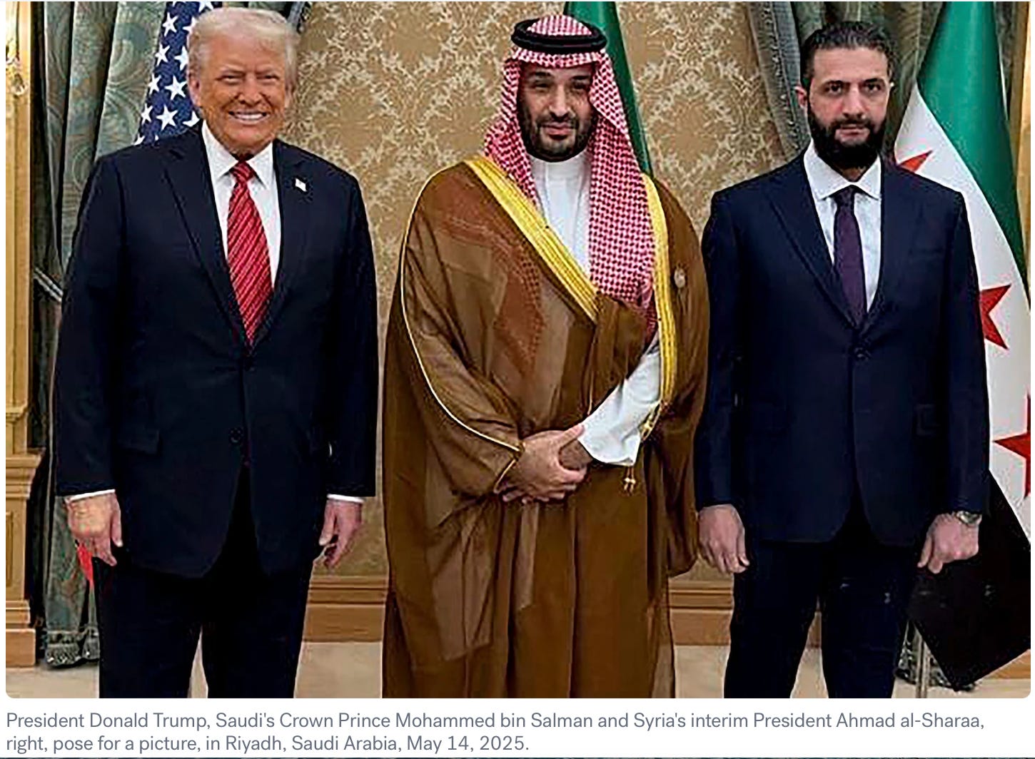 A group of men standing in front of a flag

Description automatically generated