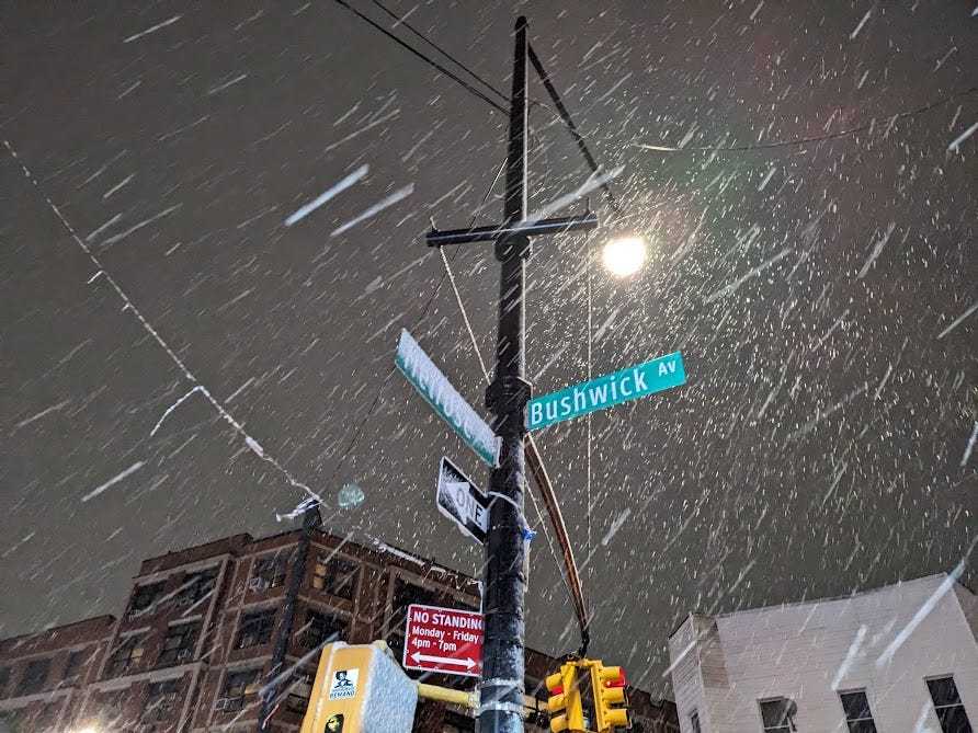 snow and sleet falls at night in bushwick, brooklyn
