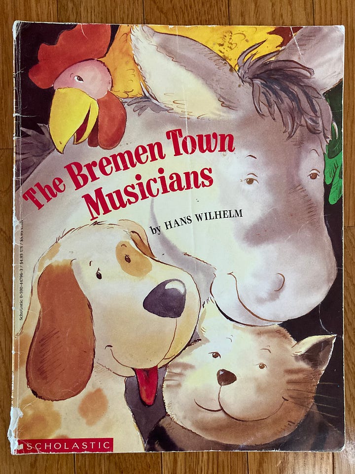 Paperback editions of four picture books including The True Story of the Three Little Pigs, Where the Wild Things Are, The Bremen Town Musicians, and David Goes to School
