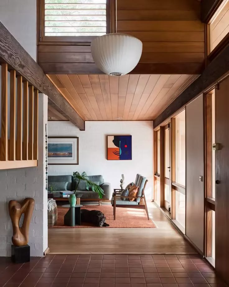 This may contain: a living room filled with furniture and a lamp hanging from the side of the wall This may contain: a living room filled with furniture and a lamp hanging from the side of the wall