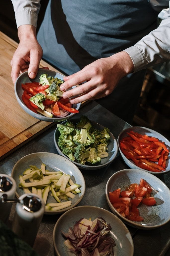 chef with bowls of vegetables