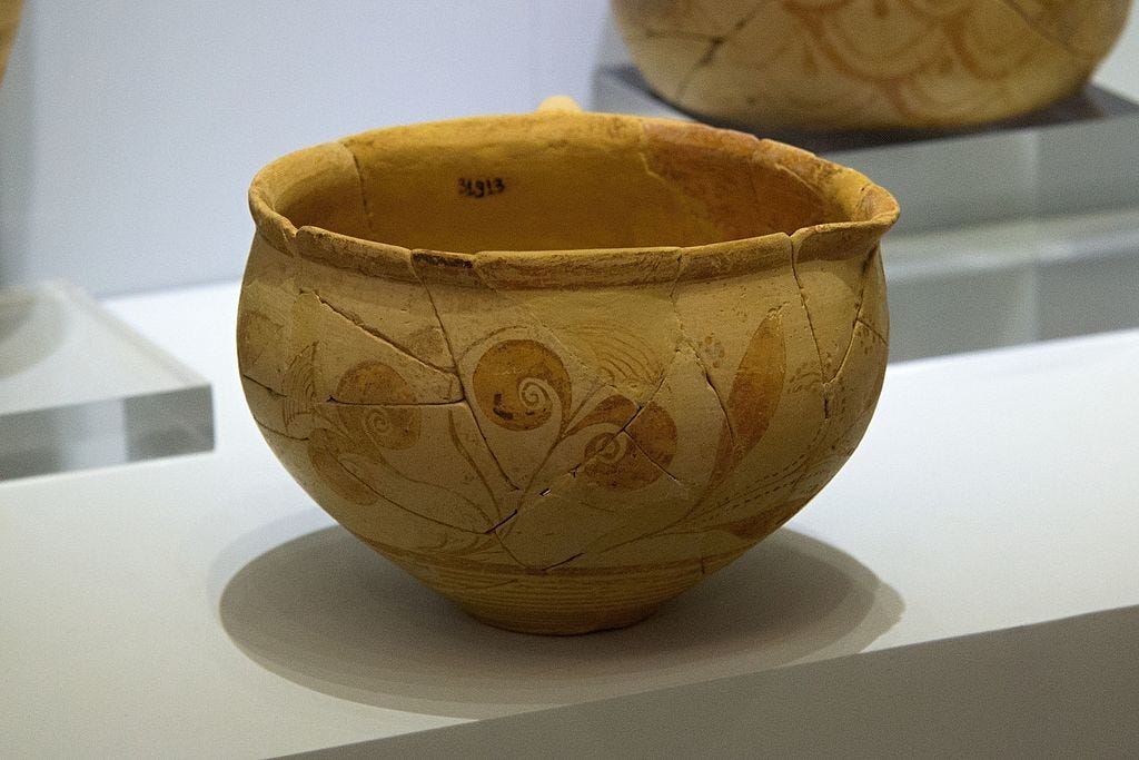 Minoan ceramic cup with painted botanical design featuring waz lilies