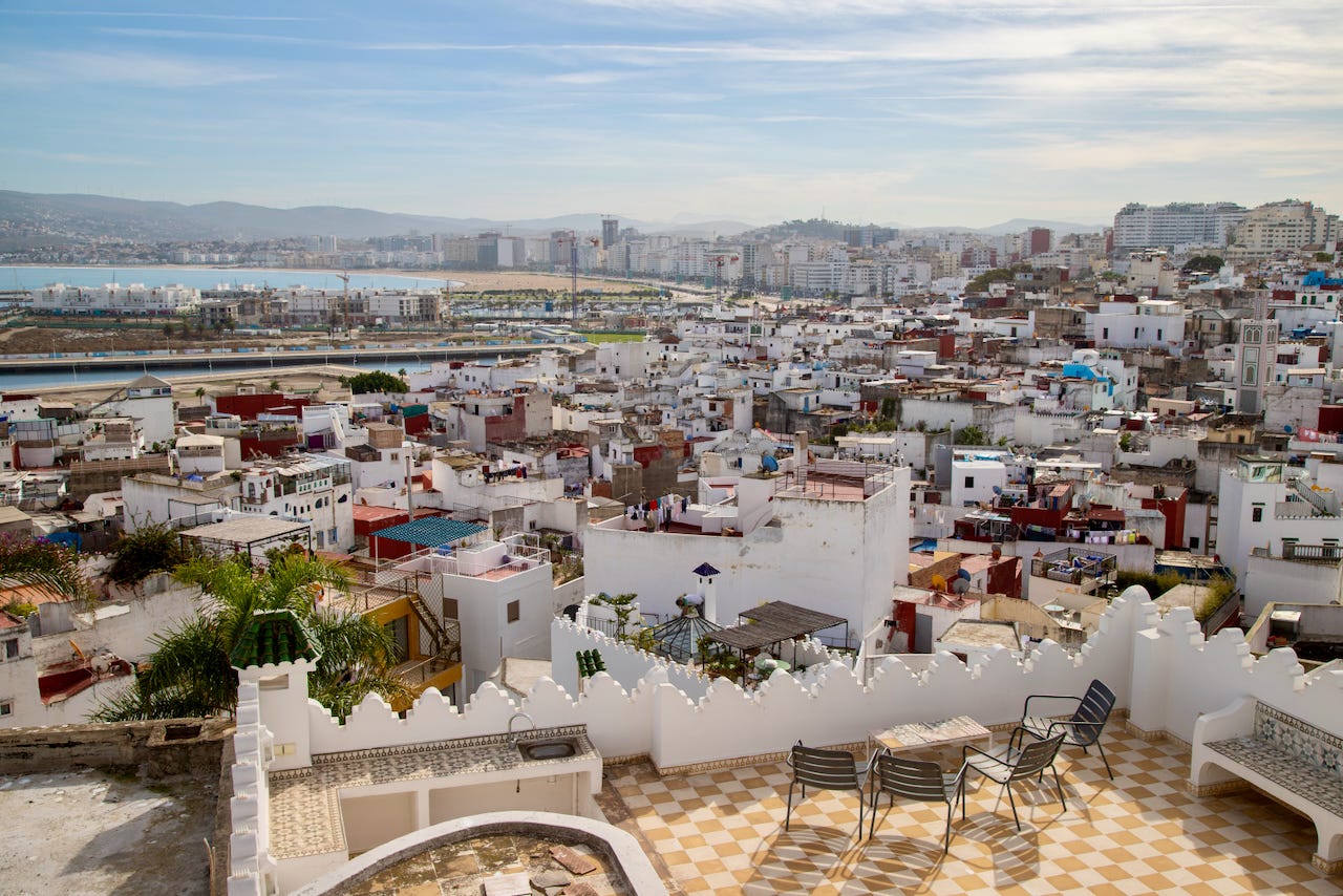 Panoramic rooftop view over the white buildings of the Tangier medina with acoastline in the distance Panoramic rooftop view over the white buildings of the Tangier medina with acoastline in the distance
