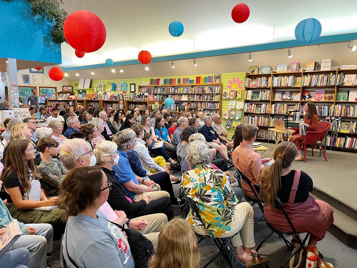 Photo of graphic novelist K. Woodman-Maynard at her release party at Red Balloon Bookshop in Minnesota, celebrating her launch of Tuck Everlasting the Graphic Novel. 