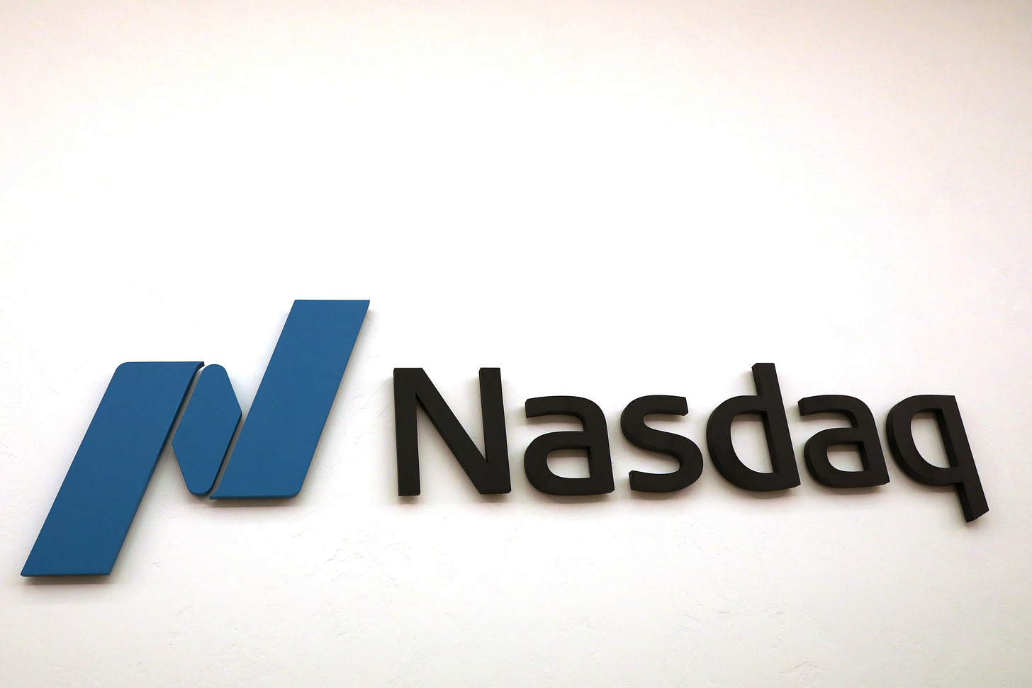 The Nasdaq logo is displayed at the Nasdaq Market site in New York