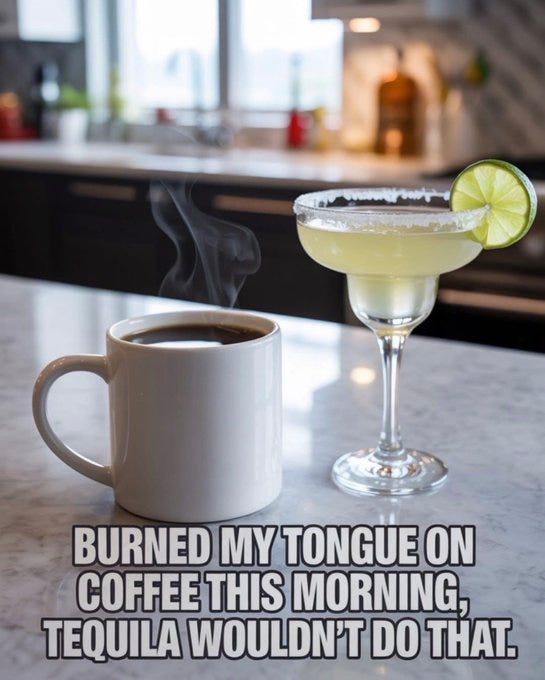 White ceramic coffee mug filled with black coffee sits on a white countertop in a modern kitchen with wooden cabinets and green plants in the background. Next to it is a classic margarita glass containing pale yellow frozen margarita topped with salt rim and a green lime wedge garnish, with steam rising from the coffee. Text overlay in black font states Burned my tongue on coffee this morning, Tequila wouldnt do that.