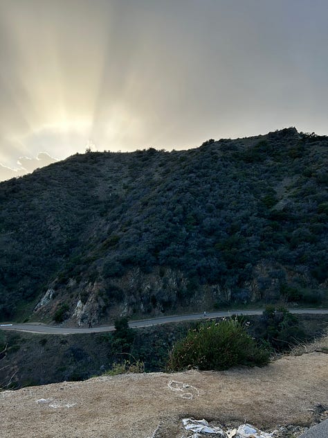 the map of the trails, views from the trails, including the locks on a fence line and the paved path down, and Hannah smiling with the Hollywood sign - pretty far behind her