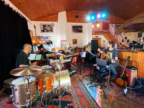Musical equipment and people inside a recording studio