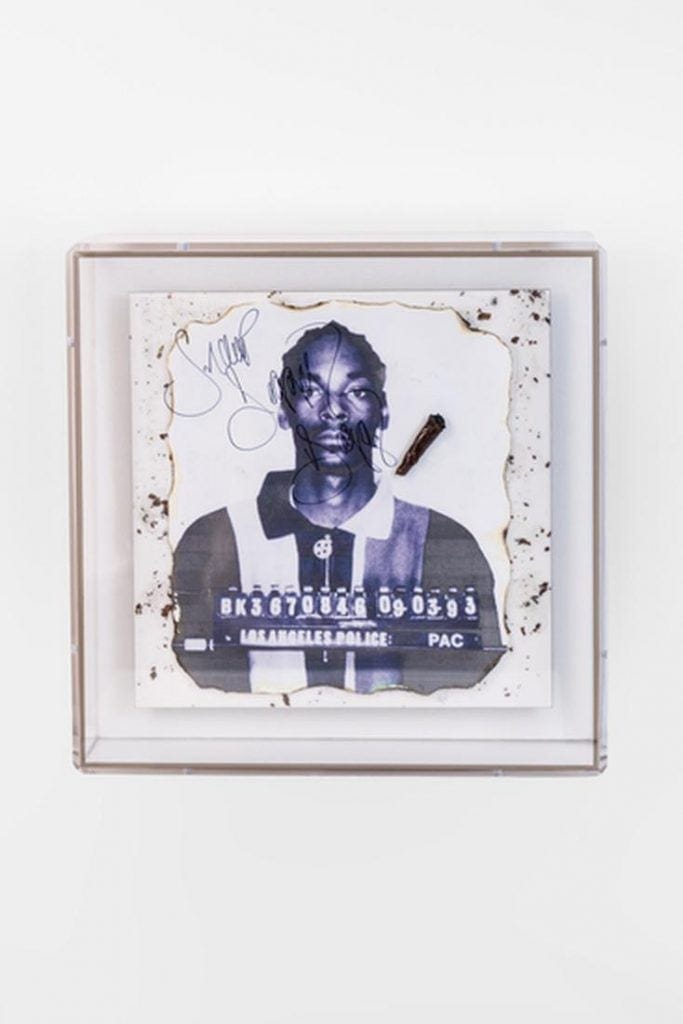 An image showing an artwork made of the mugshot of rapper Snoop Dogg in black and white, in a white frame